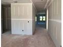 Unfinished living room space with drywall and view to future yard via two large windows at 628 Gilles Ln, Cumming, GA 30041