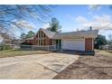 Front view of brick ranch house with driveway and chain link fence at 4386 Bluebird Ln, Lithia Springs, GA 30122