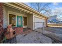 Front entry with teal door, brick accents, and a fire pit at 4386 Bluebird Ln, Lithia Springs, GA 30122