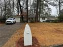 Charming white brick ranch house with a unique mailbox and a driveway at 1863 Bruce Ne Rd, Atlanta, GA 30329