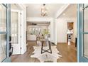 Bright entryway with hardwood floors, glass-top table, and view into living room at 1926 Fairway Ne Cir, Brookhaven, GA 30319