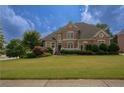 Brick house with landscaped lawn and large windows at 3374 Islesworth Trce, Duluth, GA 30097