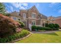 Brick house with mature landscaping and large windows at 3374 Islesworth Trce, Duluth, GA 30097