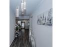 Bright hallway with modern light fixtures, hardwood floors, and stylish decor, leading to the rest of the home at 3227 Hidden Valley Cir, Lawrenceville, GA 30044