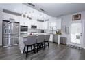 Modern kitchen featuring stainless steel appliances, granite countertops, a kitchen island, and a stylish backsplash at 3227 Hidden Valley Cir, Lawrenceville, GA 30044