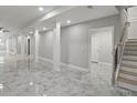 Finished basement with polished marble floor, access to stairs, and a doorway to another room at 1320 Melbenan Dr, Atlanta, GA 30311