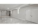 Spacious finished basement featuring a fireplace and double doors at 1320 Melbenan Dr, Atlanta, GA 30311
