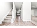 Bright entryway with tile floors, staircase, and view into the kitchen at 2916 Ward Lake Way, Ellenwood, GA 30294