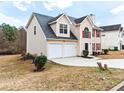 Side view of a two-story home with attached two-car garage and driveway at 2916 Ward Lake Way, Ellenwood, GA 30294