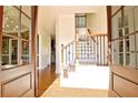 Bright entryway with hardwood floors and elegant staircase at 314 Sandalin Ln, Peachtree City, GA 30269