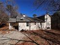 Side view of a light beige ranch house with mature trees at 3246 Wallace Lake Rd, Douglasville, GA 30135