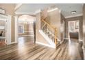Spacious foyer with hardwood floors, chandelier, staircase, and views into the office and living room at 1350 Eryn Cir, Suwanee, GA 30024