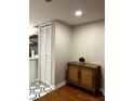 Basement storage area with white closet doors and wood cabinet at 18 Ivy Ne Rdg, Atlanta, GA 30342