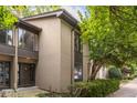 Tan two-story townhome with dark brown front door and landscaping at 18 Ivy Ne Rdg, Atlanta, GA 30342