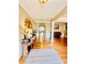 Bright entryway with hardwood floors, decorative rug and console table at 651 Hexham Ct, Suwanee, GA 30024