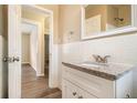 Updated bathroom with white vanity, granite countertop and subway tile at 5531 Wild Cherry Sw Dr, Mableton, GA 30126