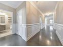 Bright hallway with dark hardwood floors and white wainscoting at 630 Eagles Lndg, Woodstock, GA 30188