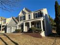 Two-story house with gray siding, two-car garage, and landscaping at 681 Courageous Ct, Lawrenceville, GA 30043