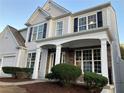 Two-story house with gray siding, stone accents, and a covered porch at 681 Courageous Ct, Lawrenceville, GA 30043