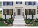 Front entrance with white stairs, black railings, and landscaping at 2907 Wickford Nw Dr, Kennesaw, GA 30152