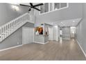Spacious living room with two-story ceiling, hardwood floors, and an open kitchen area at 4234 Stillwater Dr, Duluth, GA 30096