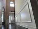 Bright foyer with hardwood floors, wainscoting and a view of the front door at 15 Blanket Pass, Covington, GA 30016