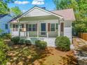 White charming ranch home with a covered porch at 311 Deering Nw Rd, Atlanta, GA 30309