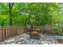 Stone patio with fire pit and wooden chairs at 311 Deering Nw Rd, Atlanta, GA 30309