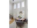 Bright dining room with hardwood floors and a modern chandelier at 10444 Park Walk Pt, Alpharetta, GA 30022