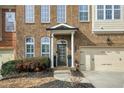 Townhome's front entrance with brick facade and dark brown door at 10444 Park Walk Pt, Alpharetta, GA 30022