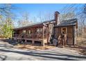 Charming log cabin with a covered porch and inviting curb appeal at 4288 Post Rd, Winston, GA 30187