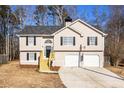 Two-story house with beige siding, double attached garage, and wood stairs at 459 Pleasant Way, Temple, GA 30179