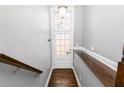 Hardwood floor entryway with coat hooks and white door at 1292 Creekside Se Ter, Smyrna, GA 30082