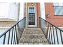 Brick steps and black railing leading to front door of townhome at 1292 Creekside Se Ter, Smyrna, GA 30082