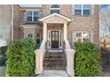 Elegant front entrance with stairs and brick facade at 4058 Rosebay Way, Conyers, GA 30094