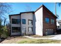 Modern home with a distinctive design featuring clean lines, large windows, and mixed materials at 4238 Paces Ferry Se Rd, Atlanta, GA 30339