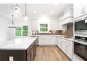 Bright kitchen with white cabinetry, granite countertops, and stainless appliances at 1020 Cottonwood Ln, Loganville, GA 30052