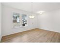 Bright entryway with hardwood floors, pendant lighting, and large windows at 7256 Eton Ln, Locust Grove, GA 30248
