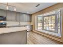 Modern kitchen boasts gray cabinets, quartz countertops, and a bay window at 16 S Eugenia Nw Pl, Atlanta, GA 30318