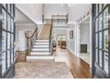 Grand two-story entryway with hardwood floors and an elegant staircase at 5060 Rosedown Pl, Roswell, GA 30076