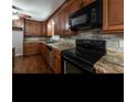 Updated kitchen with wood cabinets and granite countertops at 1792 Hammond Woods Sw Cir, Marietta, GA 30008