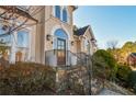 Elegant front entrance with stone steps, iron railing, and arched entryway at 605 Rose Creek Cir, Duluth, GA 30097
