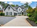 Two-story house with gray siding, black shutters, and a 3-car garage at 1409 Sheridan Ne Rd, Atlanta, GA 30324