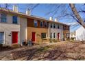 Townhome complex showcasing three units with red doors at 242 Chads Ford Way, Roswell, GA 30076