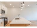 Modern kitchen island with white quartz countertop and farm-style sink at 3309 Cranston Ln, Kennesaw, GA 30144