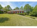 Brick home nestled on a sloping lot with ample green space at 1420 Arblay Pl, Loganville, GA 30052