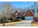 Brick two-story house with attached garage and manicured lawn at 6320 Bannerhorn Run, Alpharetta, GA 30005