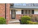 Black front door with glass panes and brick facade at 5572 Sherrell Dr, Atlanta, GA 30342