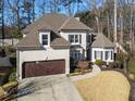 Two-story house with a large front yard and driveway at 1240 Woodlawn Ne Dr, Marietta, GA 30068