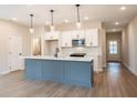 Modern kitchen with a large island, white cabinets and stainless steel appliances at 3311 Cranston Ln, Kennesaw, GA 30144